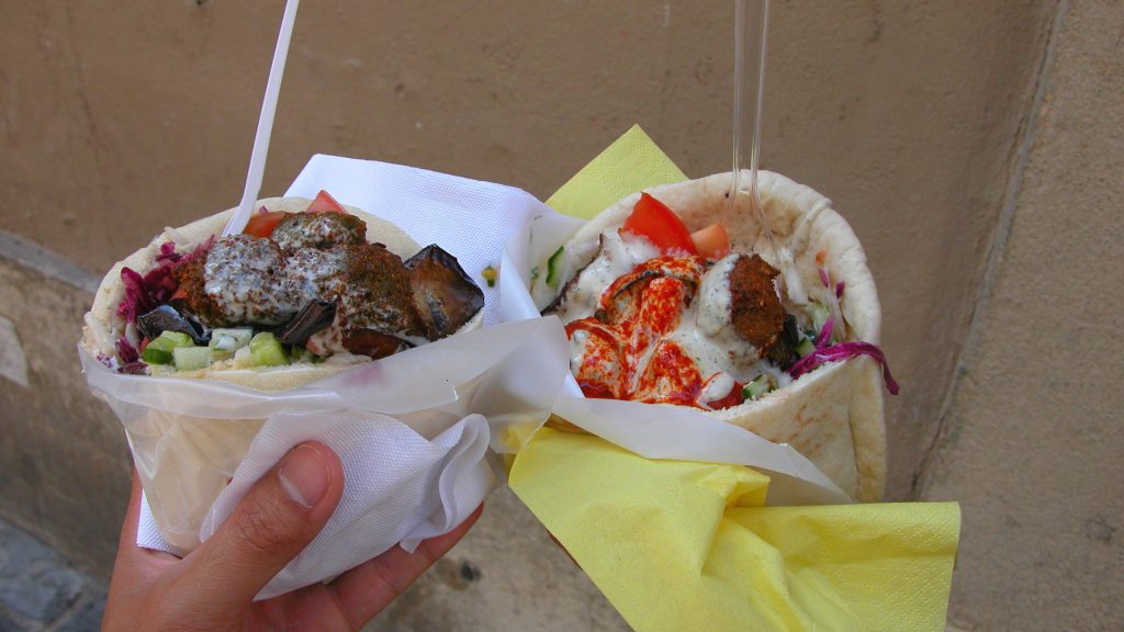Two different falafels in hand