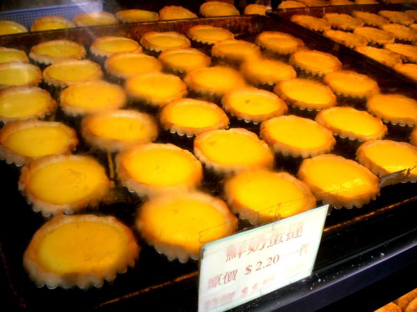 Egg tarts - https://commons.wikimedia.org/wiki/File:HK_Tsuen_Wan_%E5%BB%BA%E6%98%8E%E8%A1%97_Kin_Ming_Street_sign_Cheong_Wah_Building_Tasty_Bakery_09_Egg_tarts_a.jpg
