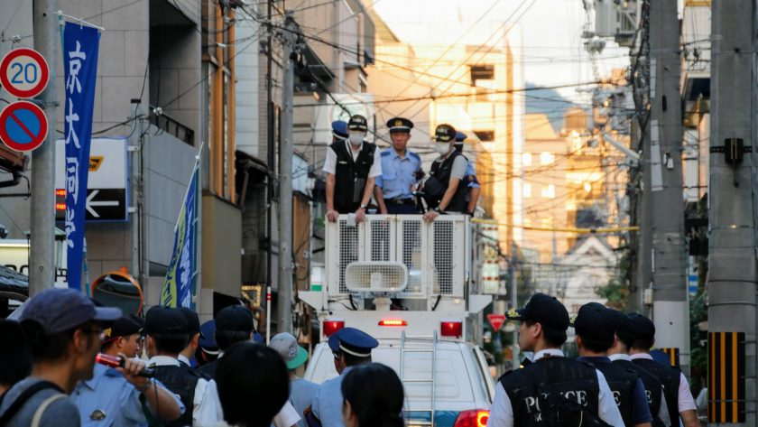 Japanese police escorting protesters